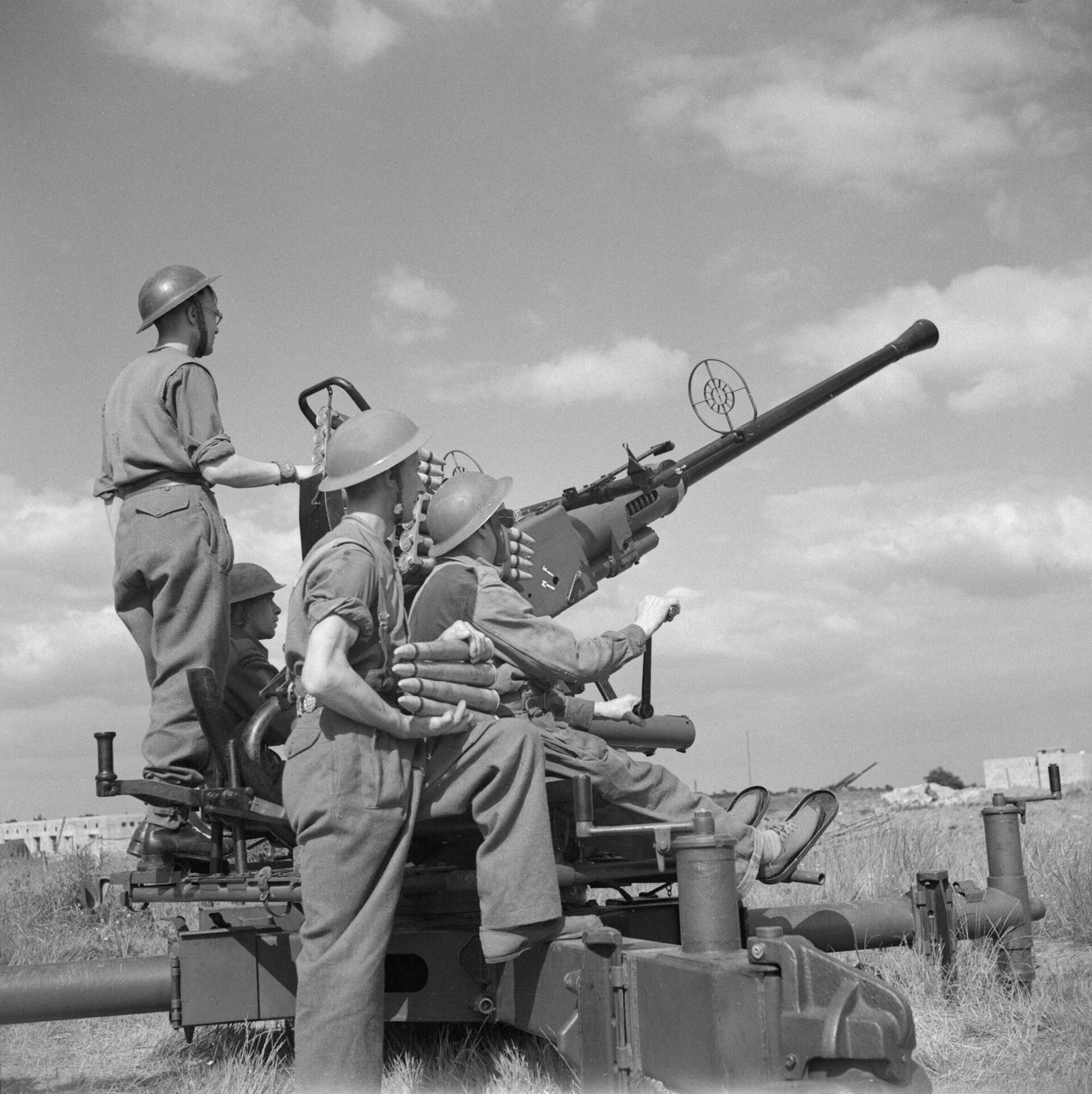 A British Bofors 40mm anti-aircraft gun crew on the gun mount, 1939-1945